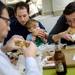 16-month-old Jackson Turer, of Ann Arbor, works on his hamburger with his parents Dave and Julie and family friend Andrew Kimball at Blimpy Burger on Wednesday, August 14, 2013. Turer's spot in line marks the official last paying customer before Blimpy Burger closes for good. Melanie Maxwell | AnnArbor.com